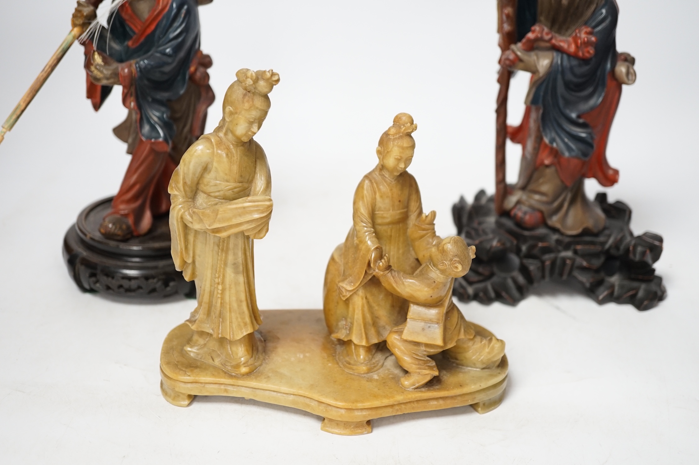 Two Chinese Fuzhou lacquer figures of Shou Lao and a smaller soapstone figure group, tallest Fuzhou figure 25cm high (3). Condition - some wear but fair